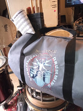 Load image into Gallery viewer, Symmetrical Drumming V3 - Duffel Bag (Grey) - Large kit bag sitting on drums holding drumsticks and sheet music - side view - Keen Eye Design