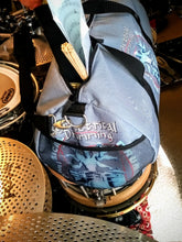 Load image into Gallery viewer, Symmetrical Drumming V3 - Duffel Bag (Grey) - Large kit bag sitting on drums holding drumsticks and sheet music - end view with webbed pouch - Keen Eye Design