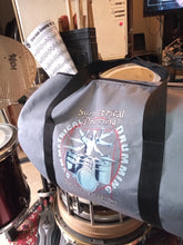 Load image into Gallery viewer, Symmetrical Drumming V3 - Duffel Bag (Grey) - Large kit bag sitting on drums holding drumsticks and sheet music - side view - Keen Eye Design
